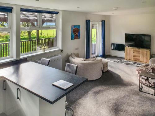 a living room with a couch and a table in a room at Classroom Two - Uk48651 in Lifton
