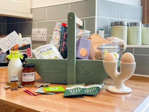 a table with a container of food and eggs on it at Pippa's Cottage - Uk42332 in Little Blencow