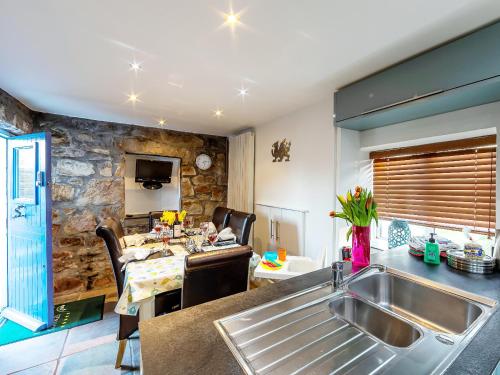 a kitchen and living room with a sink and a table at Foxes Reach - Hw7421 in Trelleck