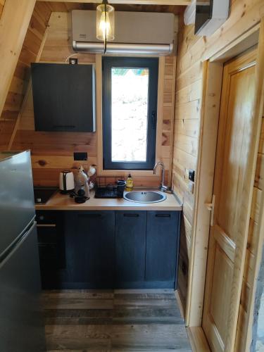 a small kitchen with a sink and a window at Villa Moonlight,Žabljak in Žabljak