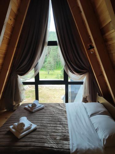 a bedroom with a bed and a large window at Villa Moonlight,Žabljak in Žabljak
