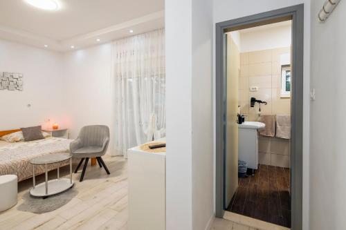 a bedroom with a bed and a desk in a room at SUPER HORIZONT- Sea View Apartments with private Jacuzzi time & Free Parking in Split