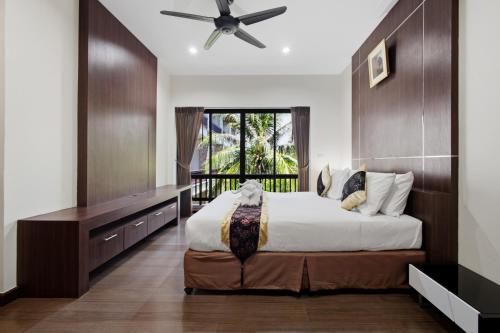 a bedroom with a large bed and a window at Rawai Grand House -SHA Plus in Rawai Beach