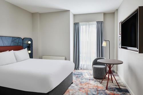 a hotel room with a bed and a table at Leonardo Hotel Newcastle in Newcastle upon Tyne