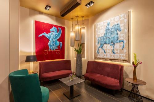 a lobby with two chairs and a painting of horses at Palazzo Navona Hotel in Rome