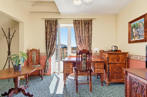 an office with a desk and chairs in a room at Päeva Villa in Haapsalu