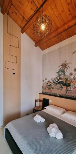a bedroom with a bed with towels on it at B&B Villa Marsico in Falerna