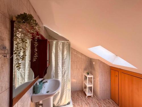 a bathroom with a sink and a shower curtain at Themis Rooms in Nea Vrasna