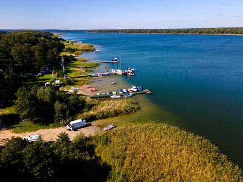 an aerial view of a lake with boats in the water at Blisko Natury Jacuzzi & Sauna in Pisz
