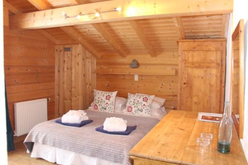 a bedroom with a bed in a wooden room at Chalet Le Plan des Rochers in Morzine