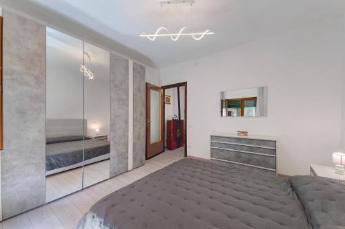 a bedroom with a bed and a mirror wall at Casa Margherita in Forno