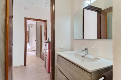a bathroom with a sink and a red refrigerator at Casa Margherita in Forno