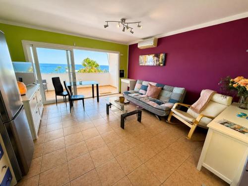 a living room with a couch and a table at Top augestattetes Apartment Monte Rojo in Maspalomas