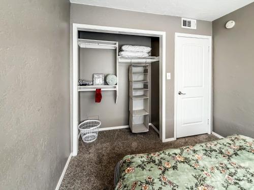 a small bedroom with a bed and a closet at Town House in Norman