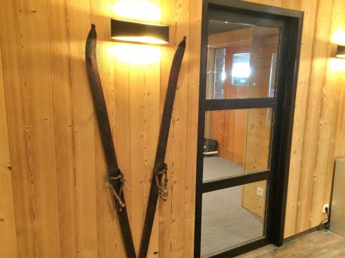 a door with two large antlers hanging on a wall at Hotel de la Jamagne & Spa in Gérardmer