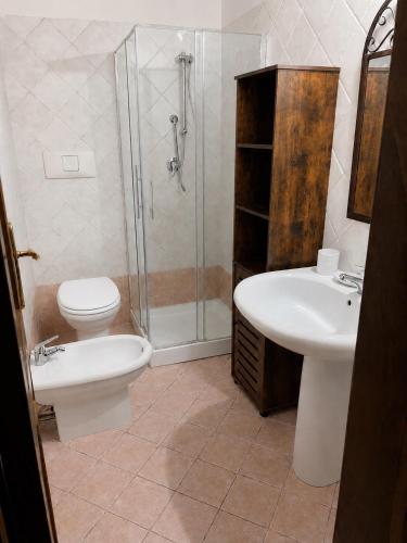 a bathroom with a toilet and a sink and a shower at Casa La Liccia in Calangianus