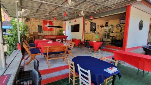 a restaurant with red and blue tables and chairs at La Belle Cliff View in Ao Nang Beach