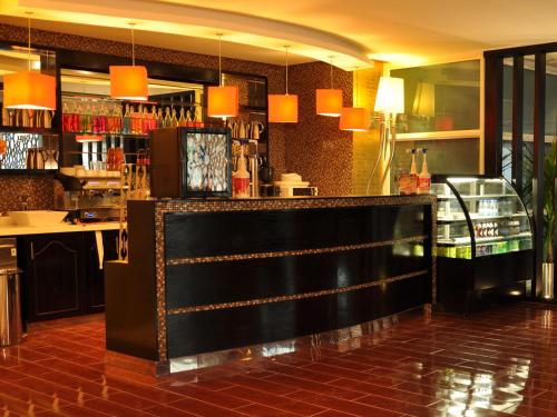 a bar in a restaurant with orange lights at Nelover Qurtubah-Serviced apartments in Riyadh