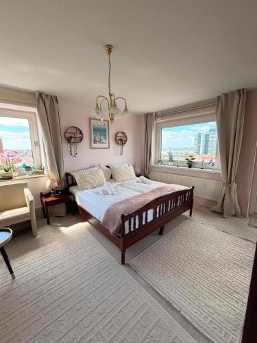 a bedroom with a bed and a large window at Deichherz - Skyline & Wohlfühlatmosphäre inklusive Parkausnahmegenehmigungsschein in Bremerhaven