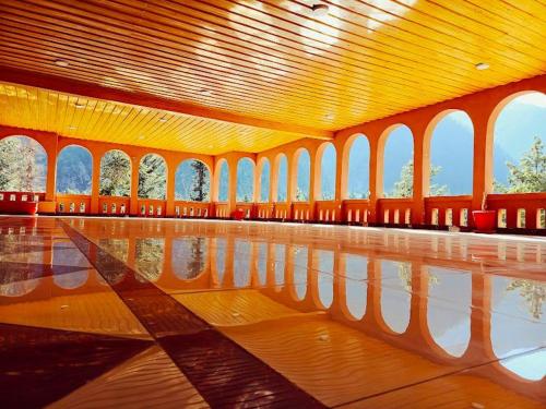 an empty room with a reflection in the water at Grand palace hotel kumrat in Tāl