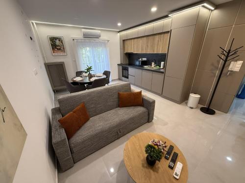 a living room with a couch and a table at ViA Lux Apartman in Pécs