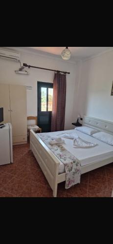a bedroom with two beds and a window at Agron S in Vlorë