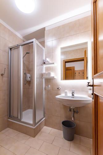 a bathroom with a shower and a sink at Gasthof Anich in Natz-Schabs