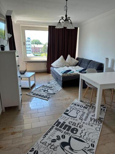 a living room with a couch and a table at Westblick in Plön