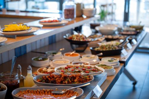 a buffet with many plates of food on a table at Glamping -420 in Kalia