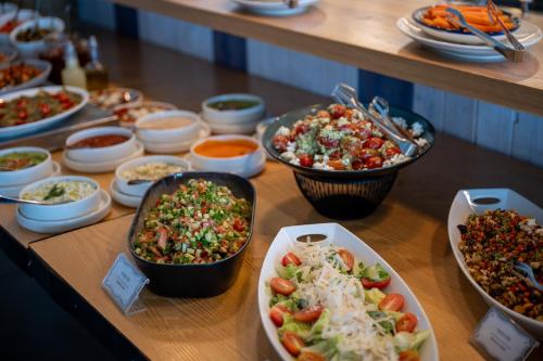a table with many different dishes of food on it at Glamping -420 in Kalia