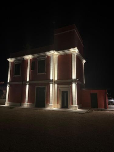 a house with lights on the front of it at night at Tenuta MAREALE in Anzio