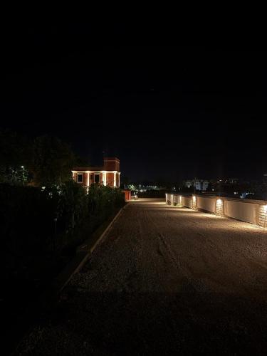 an empty street at night with a building in the background at Tenuta MAREALE in Anzio