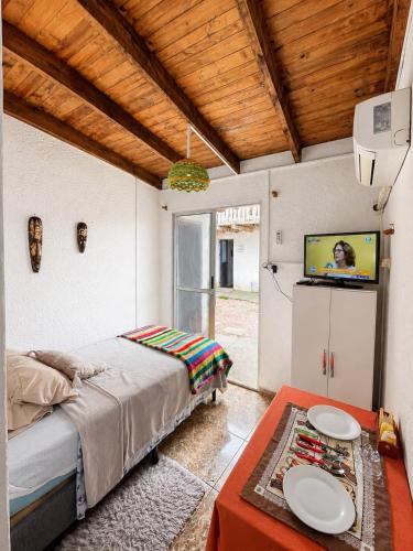 a bedroom with a bed and a flat screen tv at Alojamiento EYO en Chuy con Baño Privado y Aire Acondicionado in Chuy