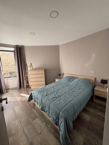 a bedroom with a large bed and a window at L'estaou in Lavoûte-Chilhac