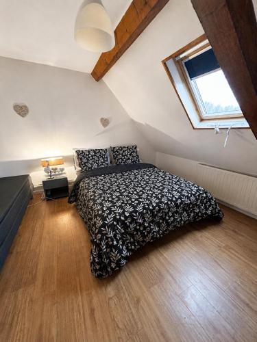 a bedroom with a bed and a window at La maison du soleil in Cappellebrouck