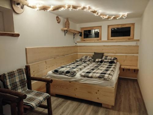 a bedroom with a bed and a chair in it at Duna Kabin in Rácalmás