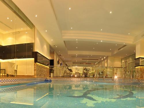 a large swimming pool in a building at Nelover Qurtubah Hotel in Riyadh