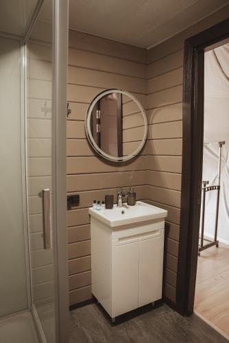 a bathroom with a sink and a mirror at Глемпінг Zatuшшя in Berezovka