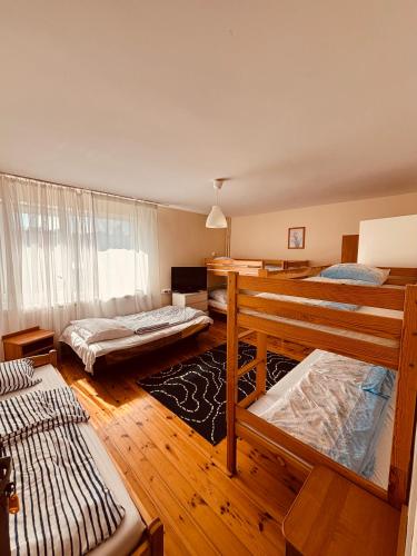 a bedroom with two bunk beds and a window at Dom wczasowy Riviera in Ustronie Morskie