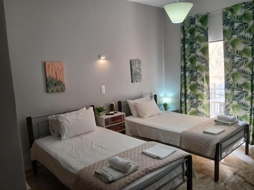 a bedroom with two beds and a window at Αγγελικη in Kyparissia