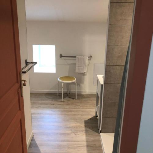 a bathroom with a sink and a table in a room at Les Lilas piscine partagée in Les Vans
