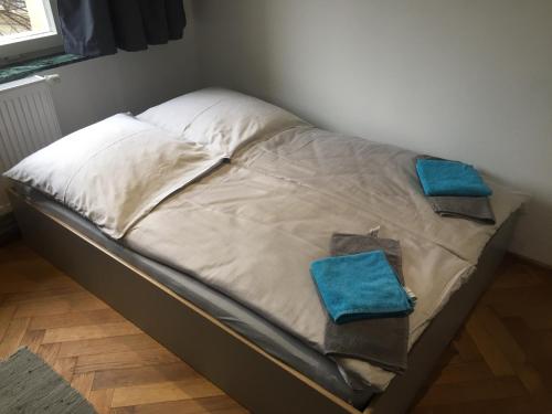 a small bed with two blue pillows on it at P63 City Rooms Nürnberg Center in Nürnberg