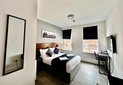 a bedroom with a bed and a mirror in it at Trivelles Liverpool in Liverpool