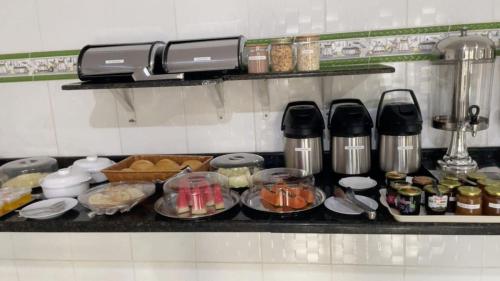 a kitchen counter with food and ingrediants at Delta Hotel Nova Mutum in Nova Mutum