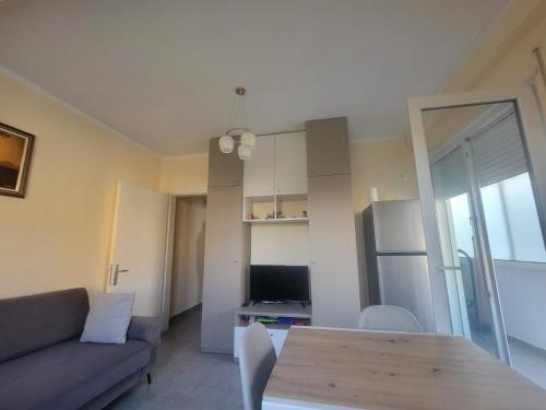 a living room with a couch and a table at Ibra apartament in Golem