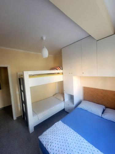 a room with two bunk beds and a bed at Ibra apartament in Golem