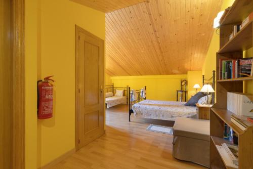 a room with a bedroom with a bed and a fire extinguisher at Casa Montenegro Las Colladas in Las Colladas