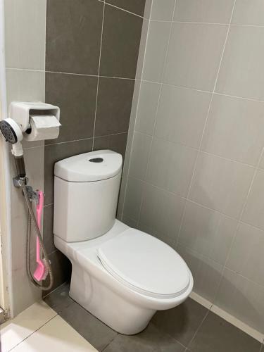 a bathroom with a white toilet in a room at Crystal Studio Apartment D'Perdana in Kota Bharu