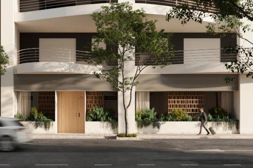 a man walks past a building on a street at Hostal Serea in Denia