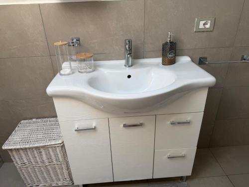 a bathroom with a white sink and a shower at EDO'S HOME in Lonate Pozzolo